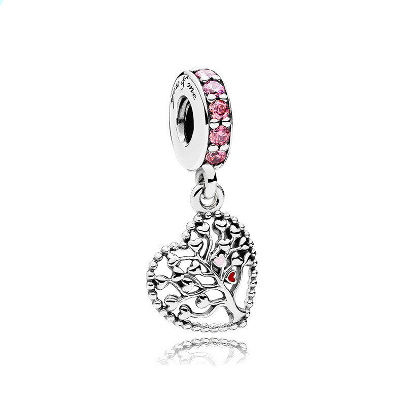 Silver charm with pink and red stones on a white background