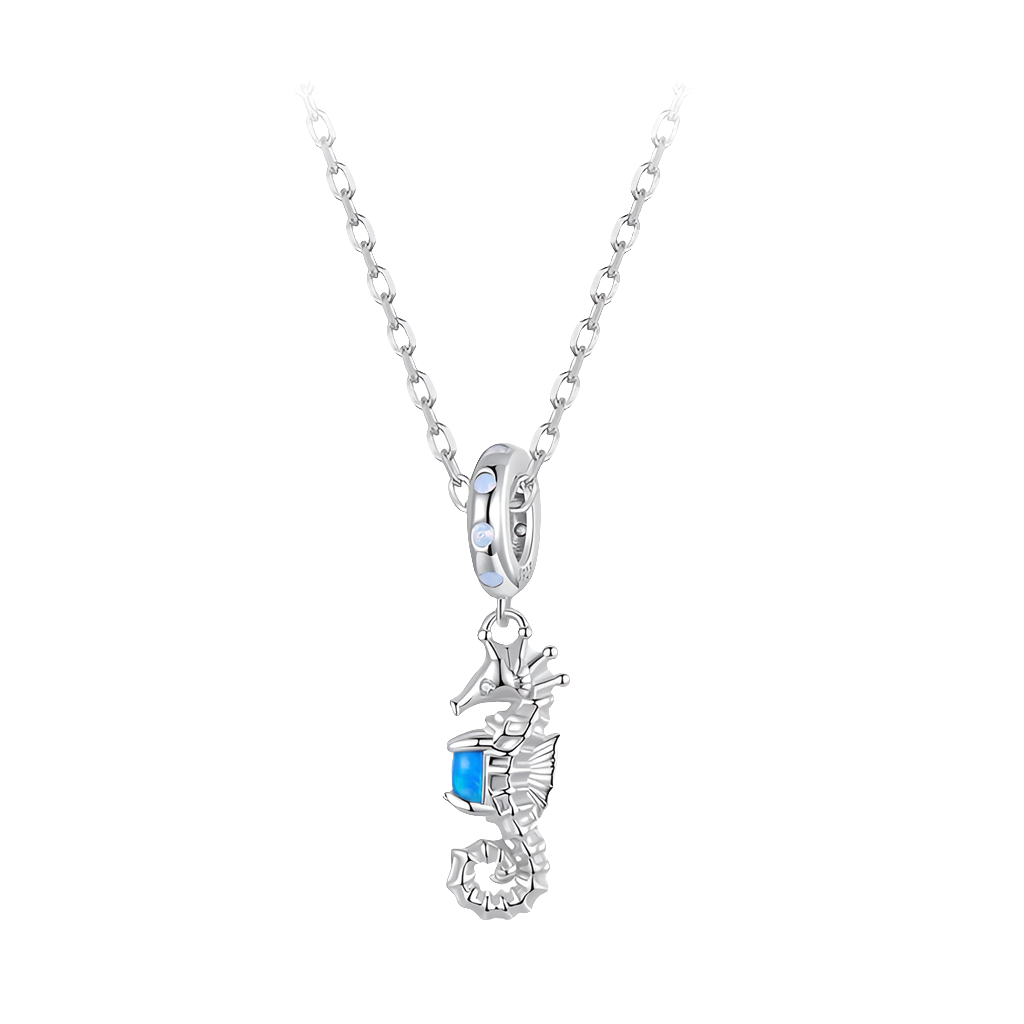 Silver seahorse pendant with a blue gemstone on a white background