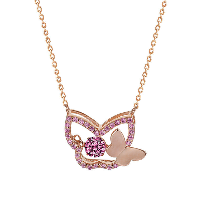 Rose gold butterfly necklace with pink gemstones on a white background