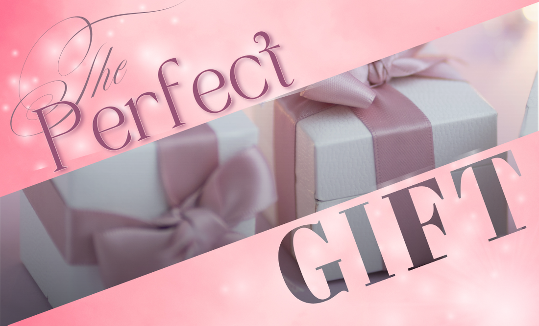 An elegant display of gift bixes with pink ribbon on a soft pink background with the halves of a pink gradient with the text "the perfect gift"