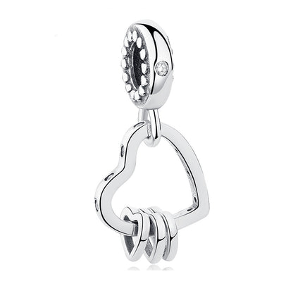 Silver heart-shaped pendant with a key design on a white background