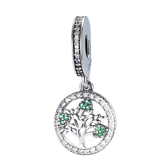Silver pendant with green gemstones on a colorful background