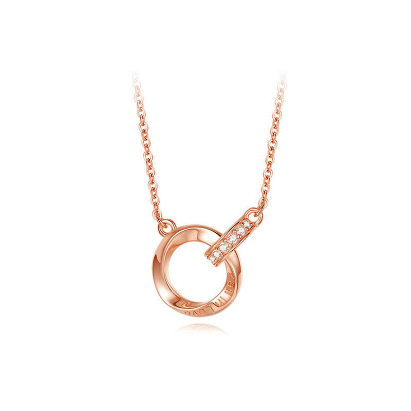 Rose gold necklace with a circular pendant on a white background
