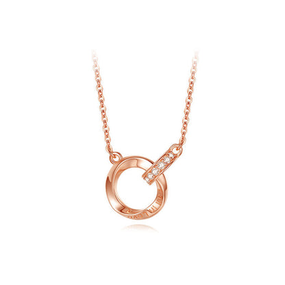 Rose gold necklace with a circular pendant on a white background