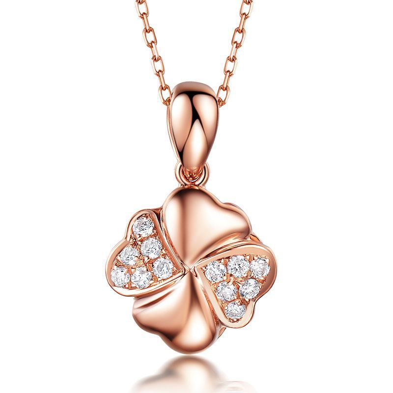 Rose gold four-leaf clover pendant with diamonds on a white background