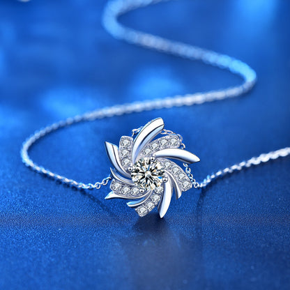 Silver necklace with a decorative pendant on a blue background