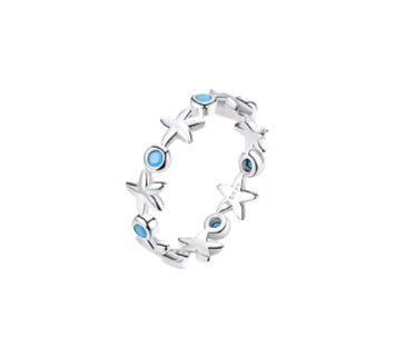 Silver ring with star and blue gemstone designs on a white background