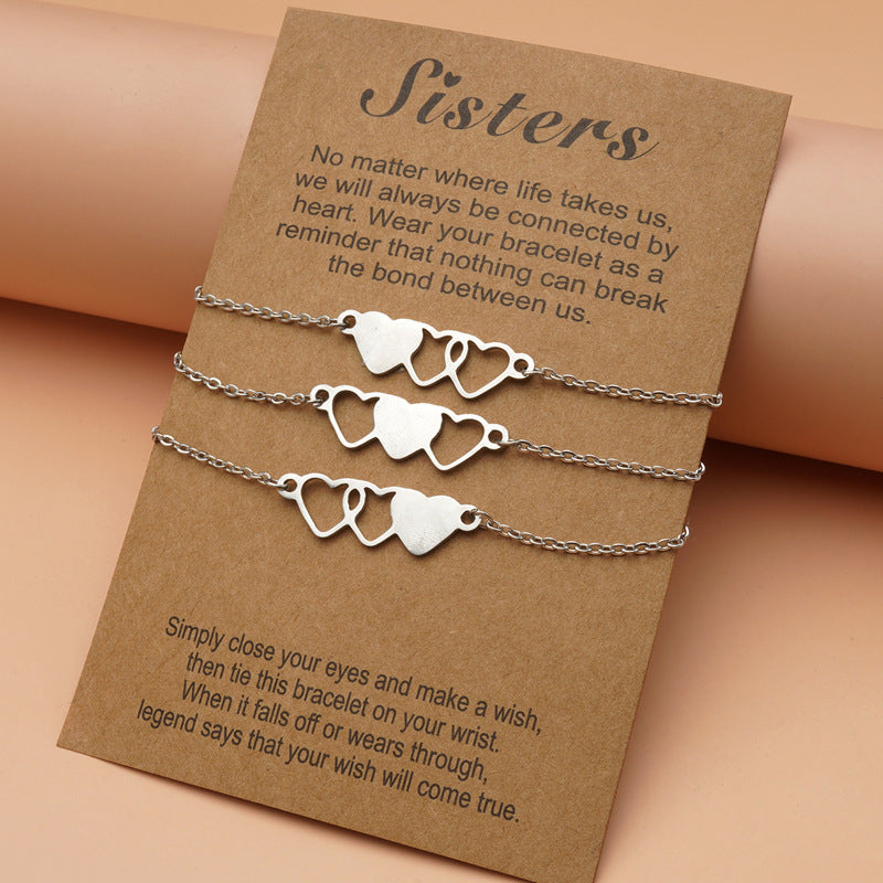 Silver heart-shaped bracelet set on a brown card with text