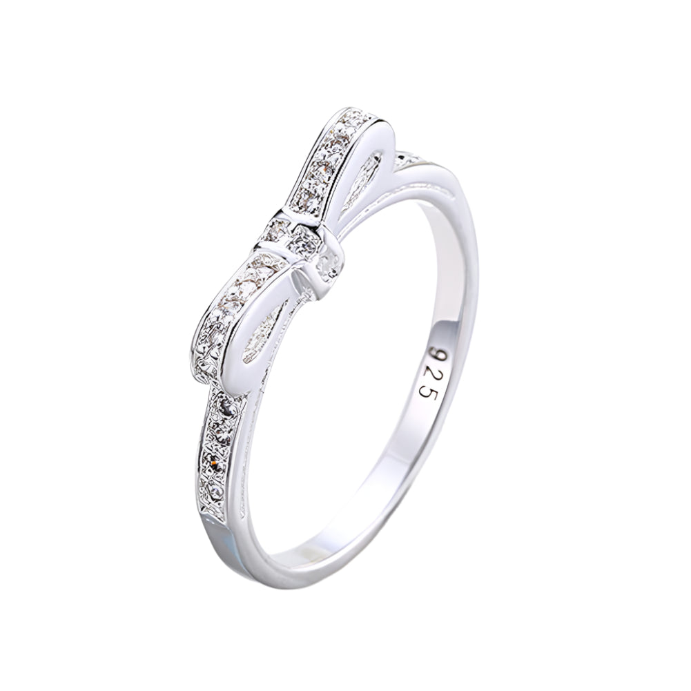 Silver ring with diamonds on a light gray background