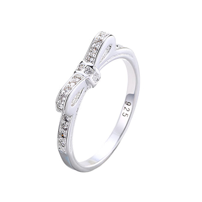 Silver ring with diamonds on a light gray background