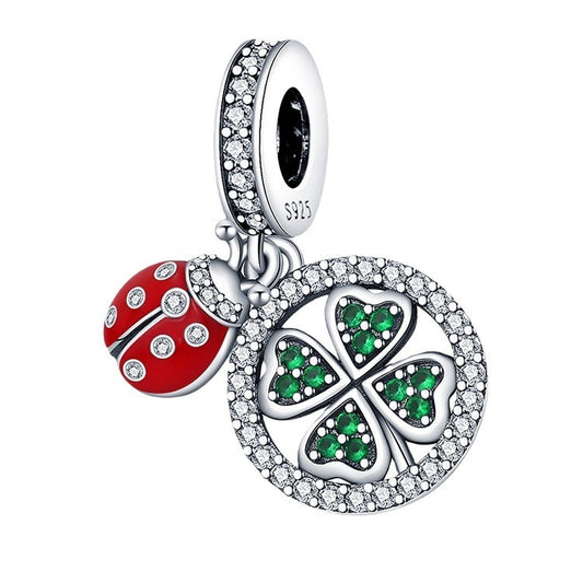 Jewelry charm with red ladybug and green clover design on a white background