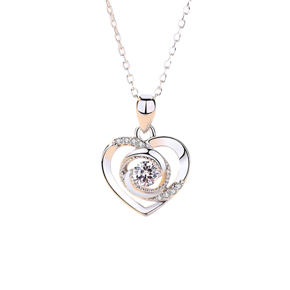 Heart-shaped pendant necklace with a diamond on a white background