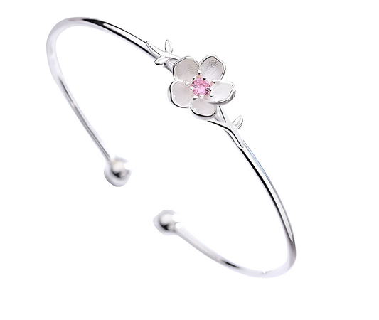 Silver bracelet with a floral design on a white background