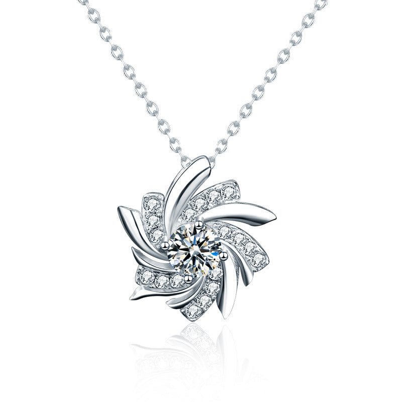 Silver necklace with a floral pendant on a white background